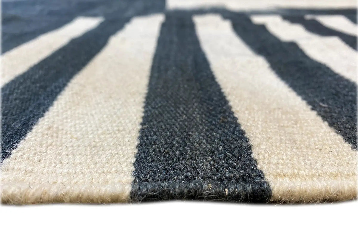 Short-pile rug with a sharp striped pattern in dark blue and cream