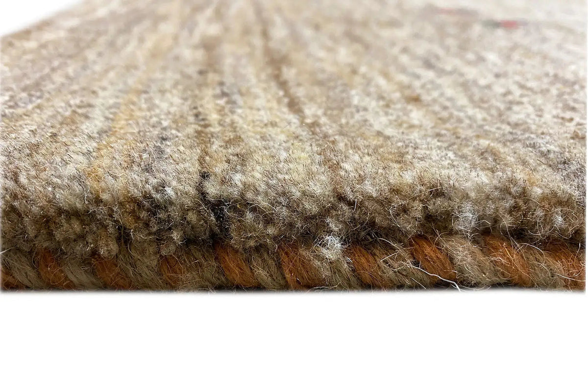 Gabbeh rug: Detail of the rug edge with dense multicolored pile and short pile height
