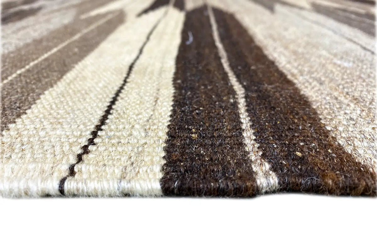 Close-up of a Kilim Qashqai rug: pile and striped bands of brown and beige color
