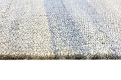 Kelim dhurrie rug close-up: pile and woven edge in light blue/beige