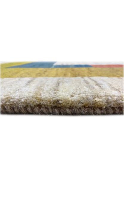 Gabbeh rug close-up of the pile surface at the edge, multicolored border and fringes.
