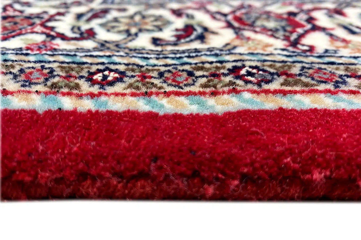 Carpet edge with red pile and visible edge, close-up