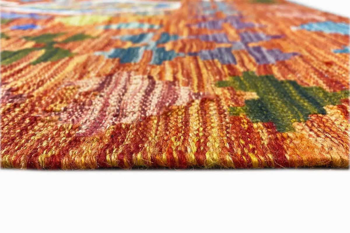 Ribbed kilim weave with a fringed edge; orange, green, and blue tones in the detail