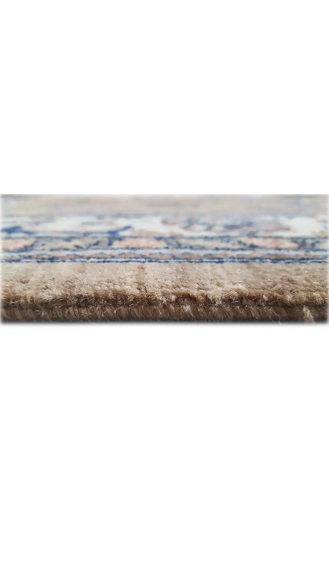 Rug edge with beige pile and blue finishing border, fringes at the bottom