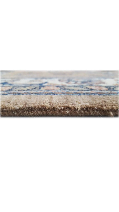 Rug edge with beige pile and blue finishing border, fringes at the bottom