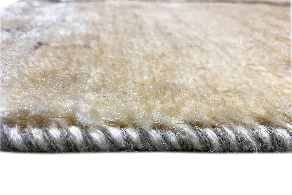 Gabbeh Lori rug edge with dense fringes in gray and beige