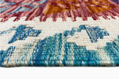 Kilim edge with selvedge and fringes, detail of a blue and red pattern