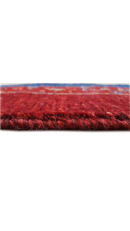 Oriental rug fringe in red, with a blue border along the hem