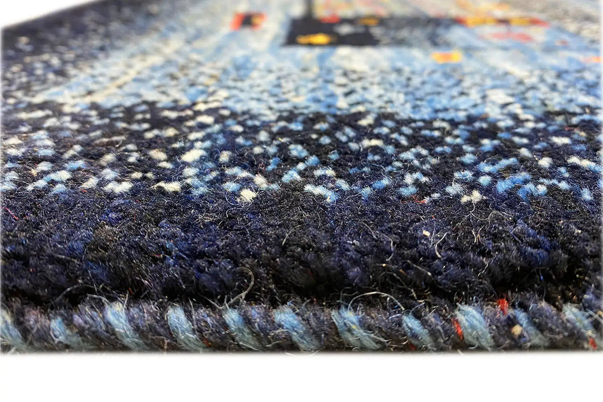 Gabbeh rug: detailed pile texture with dense, dark blue and light fibers
