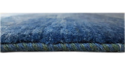 Carpet detail: dense pile in dark blue with a visible edge