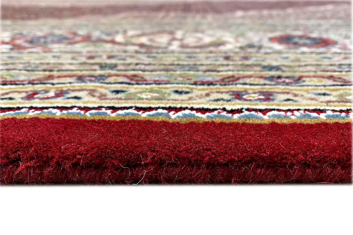 Carpet edge with short pile and fringes, edged in red, side detail view