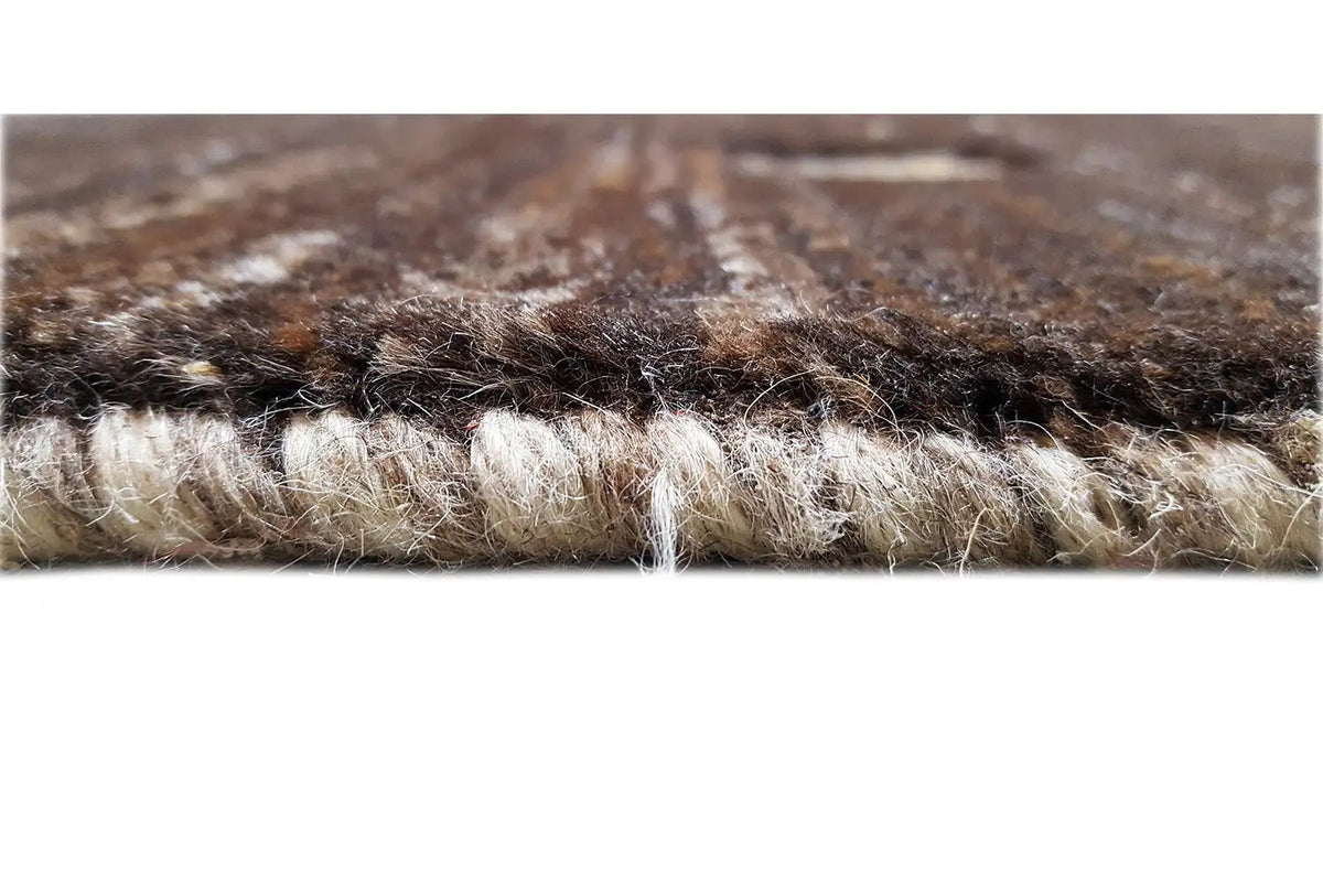 Gabbeh rug close-up: dense pile material with visible fibers and edge