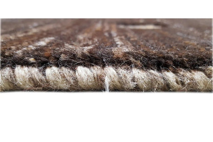 Gabbeh rug close-up: dense pile material with visible fibers and edge
