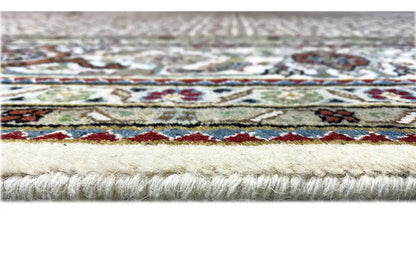 Indo Tabriz rug close-up: border pattern with fringes and pile.