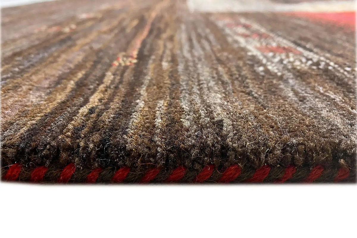 Carpet view: dense brown pile, red border at the edge, textured surface