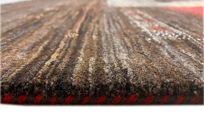 Carpet view: dense brown pile, red border at the edge, textured surface