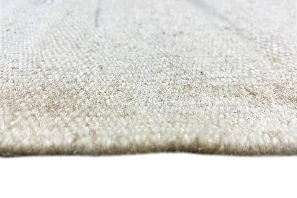 Close-up of the pile of a kilim rug: light, short, and dense texture