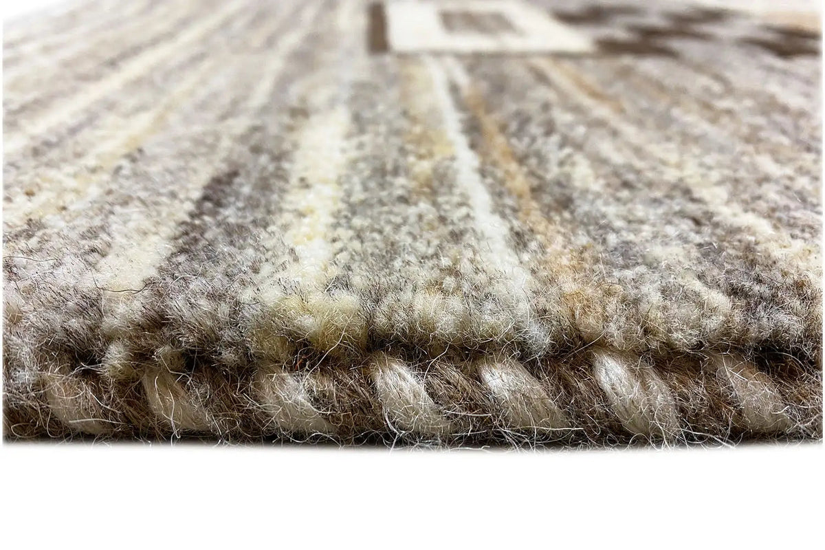 Gabbeh rug, close-up: fine pile with a gray-beige pattern and visible texture