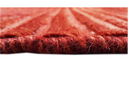 Close-up: red carpet edge with dense pile and visible selvedge