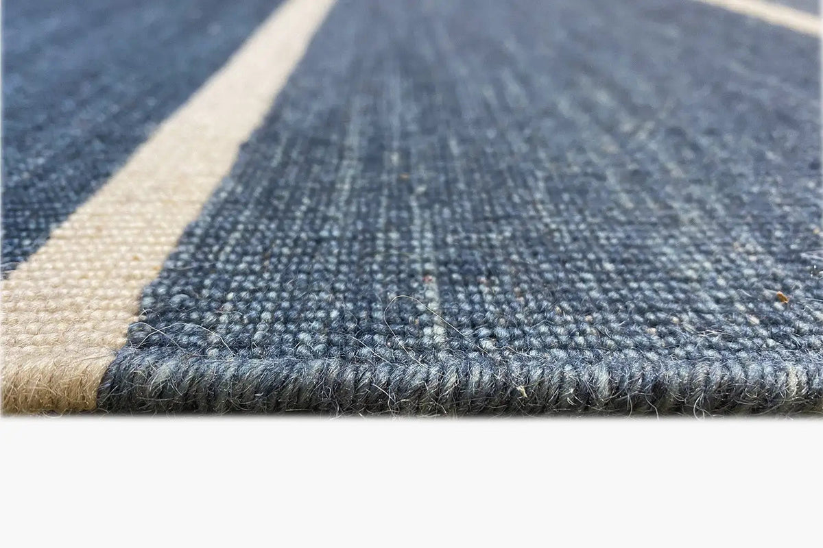 Kilim edge with beige finish and dark blue weave structure in close-up detail