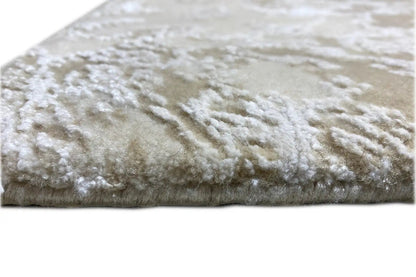 Designer rug edge view: beige pile with a white pattern and short pile height