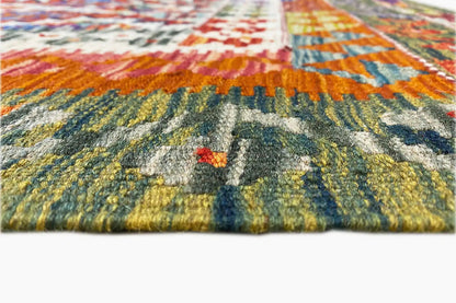 Kilim rug with a dense texture, vibrant colors, and a visible edge