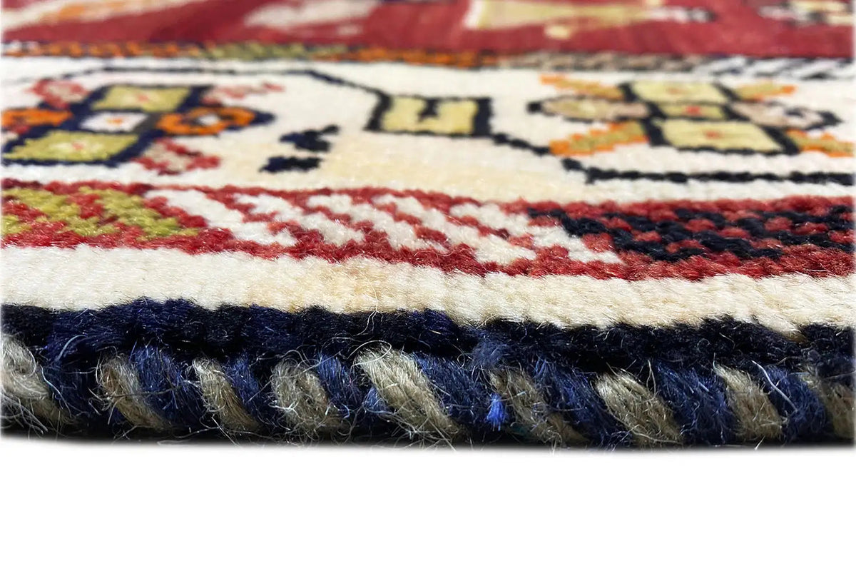 Gabbeh rug detail of the fringe, dark blue pile with colorful patterned lines