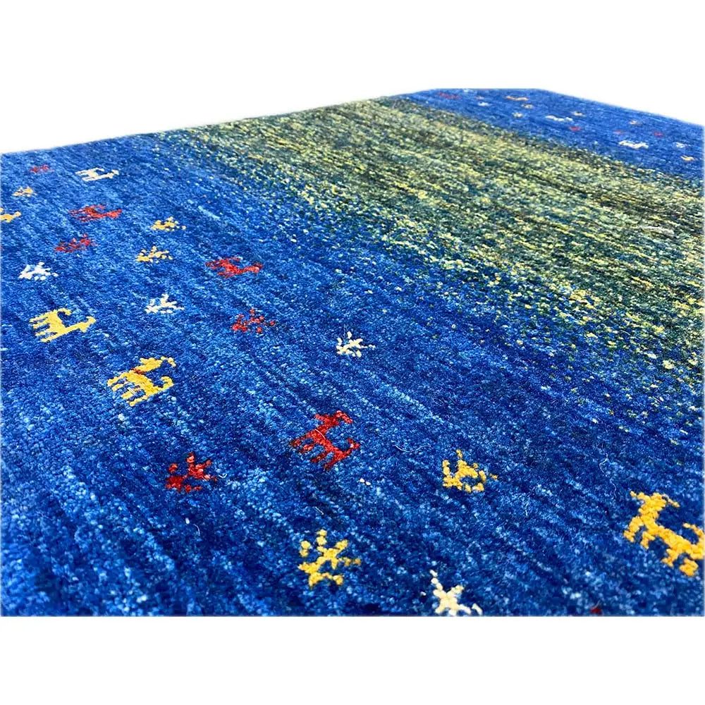 Close-up: blue-green Gabbeh with colorful animal patterns