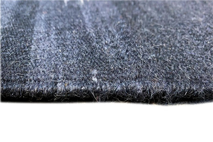 Close-up: blue-gray carpet pile with a short, dense surface