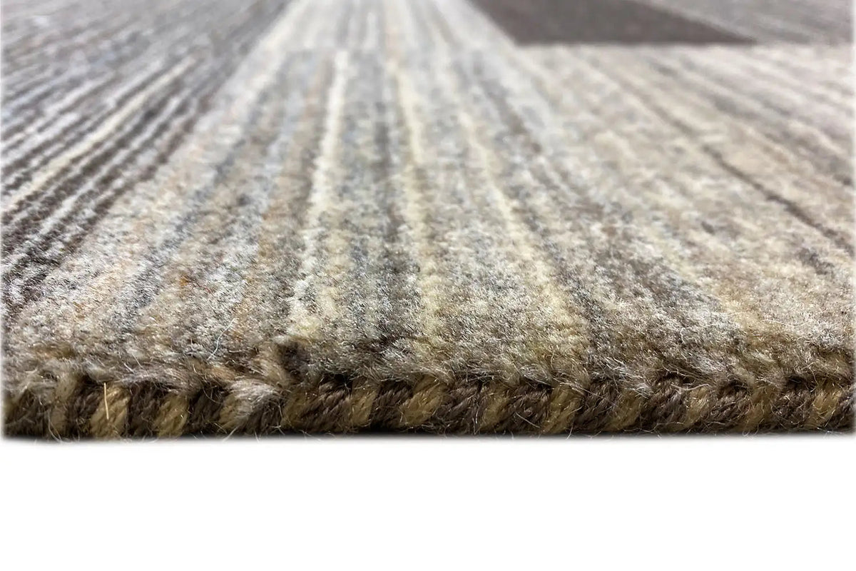 Gabbeh rug close-up: short pile, twisted texture, and multicolored stripes near the edge