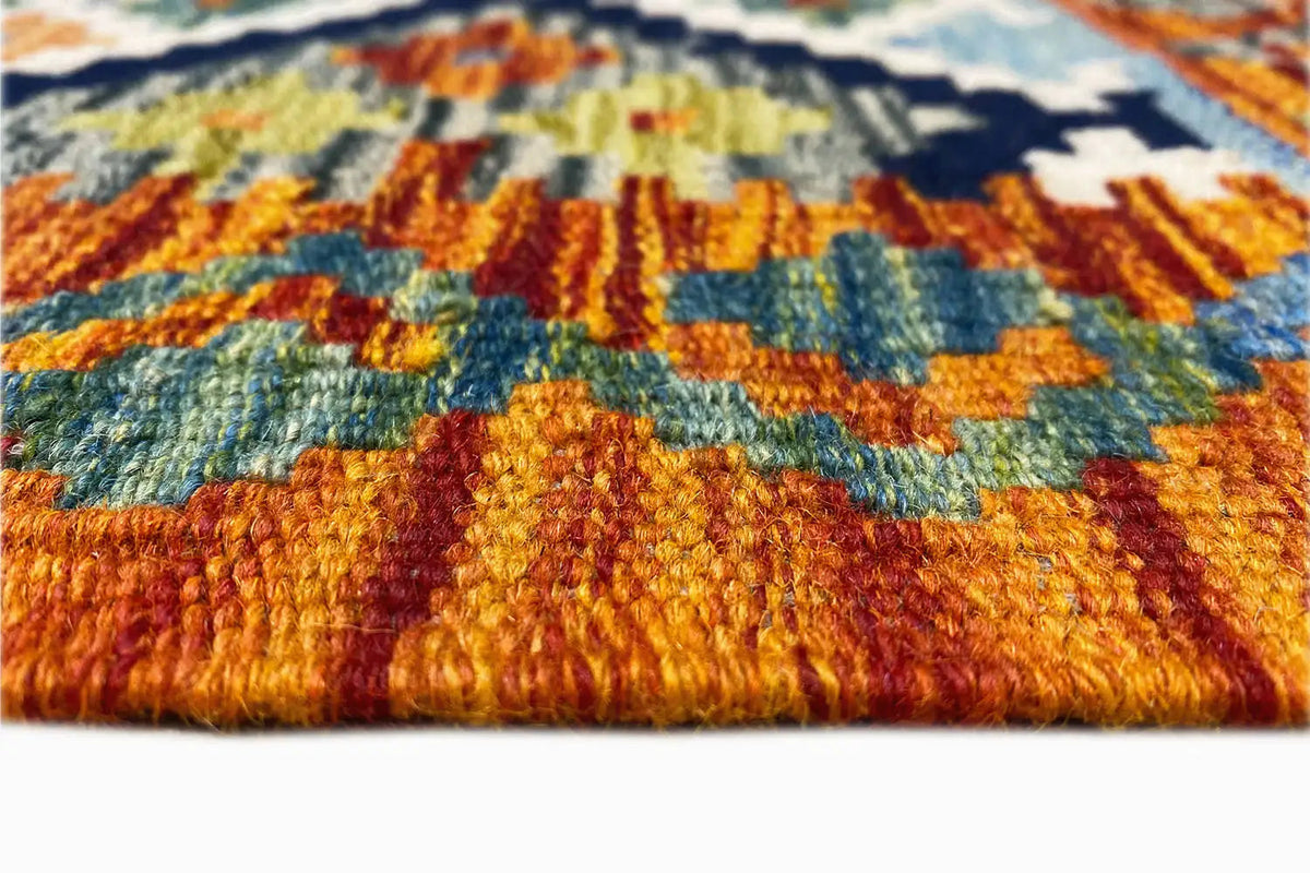 Kelim runner close-up: dense pile with orange, blue, and green threads