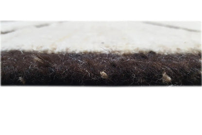 Close-up of Gabbeh rug: dark edge and fine pile with fringes