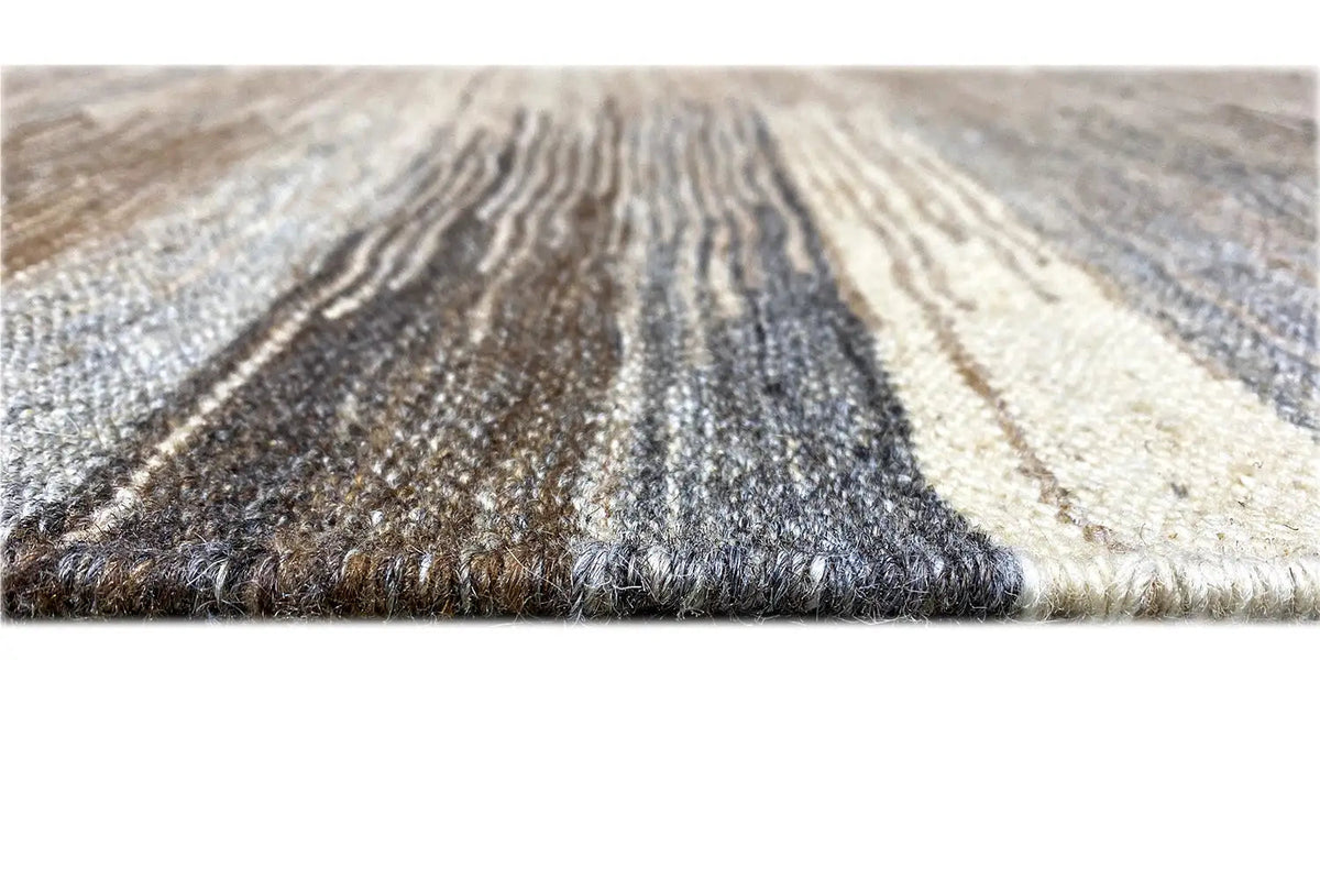 Kilim Qashqai rug detail with fringes and a mottled pattern in gray and beige