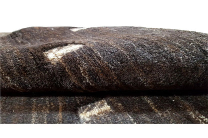Gabbeh carpet pile detail, dark fibers with beige inclusions on the top surface