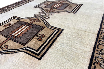 Detailed view: brown medallion with ornaments and a border on a beige background.