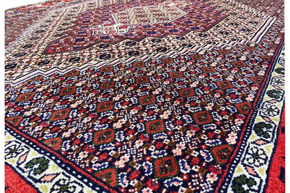 Carpet detail view: ornamental pattern of small motifs in dark red, blue, and beige