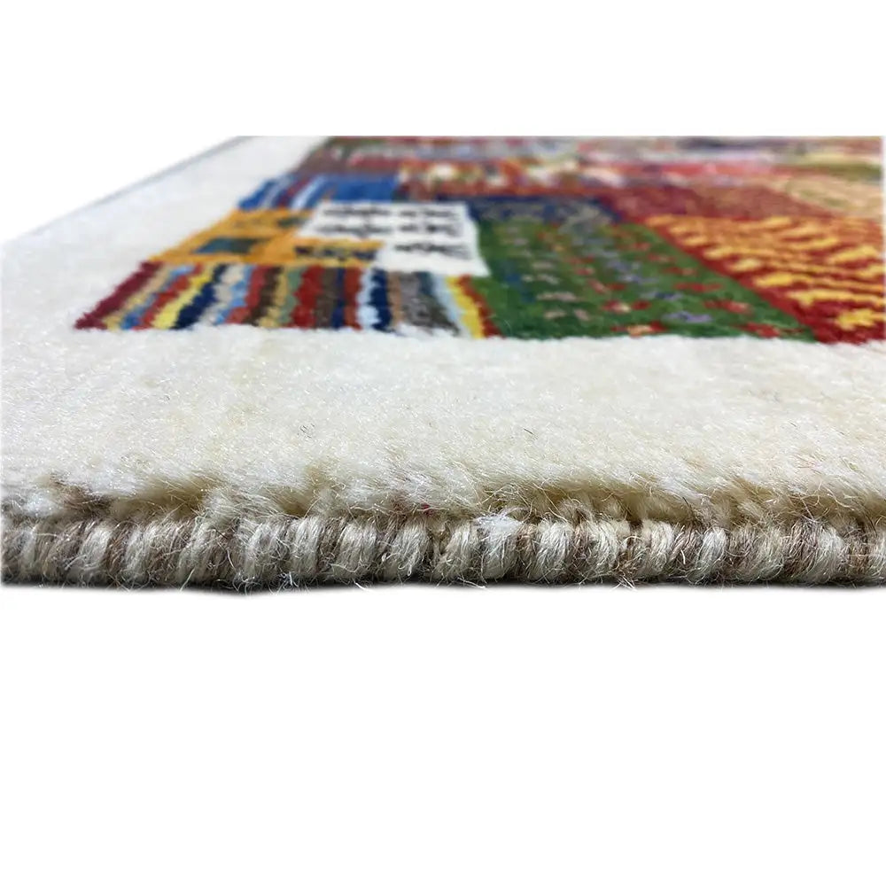 Gabbeh rug edge with fringe, light wool, and multicolored patterned areas