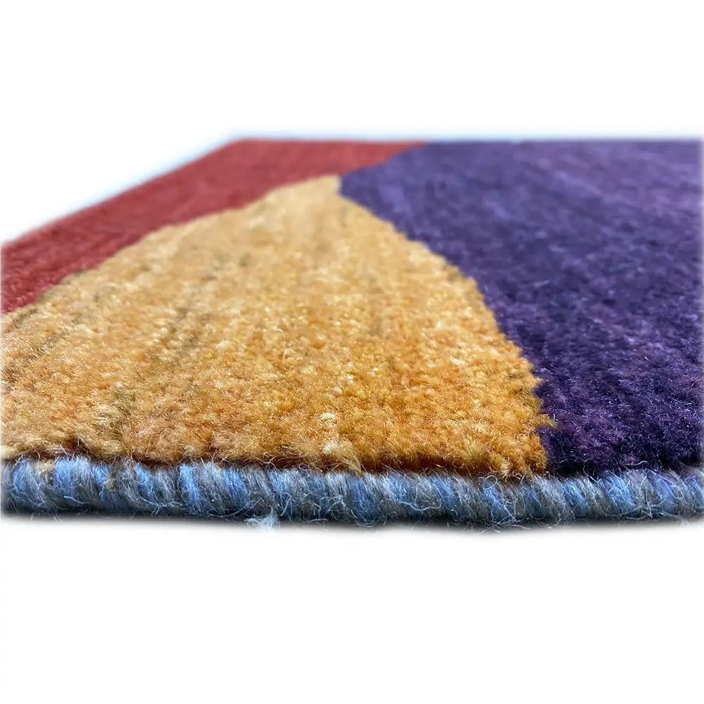 Gabbeh rug edge view with pile and narrow border; colors purple, cream, blue