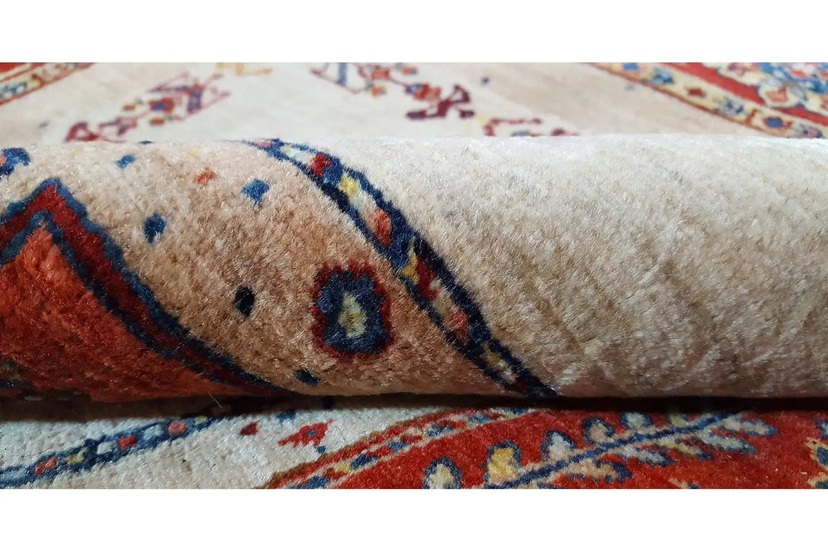 Carpet detail with short pile, a beige field, and blue and red ornaments