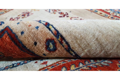 Carpet detail with short pile, a beige field, and blue and red ornaments