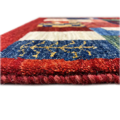 Gabbeh rug close-up of the pile end: red-blue color blocks with patterns.