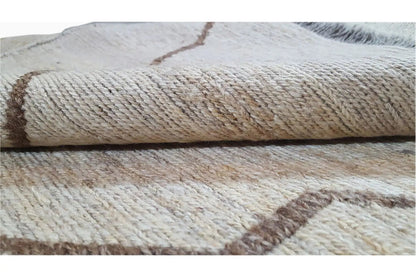 Close-up of the woven texture of a kilim rug, beige material with brown and gray discoloration