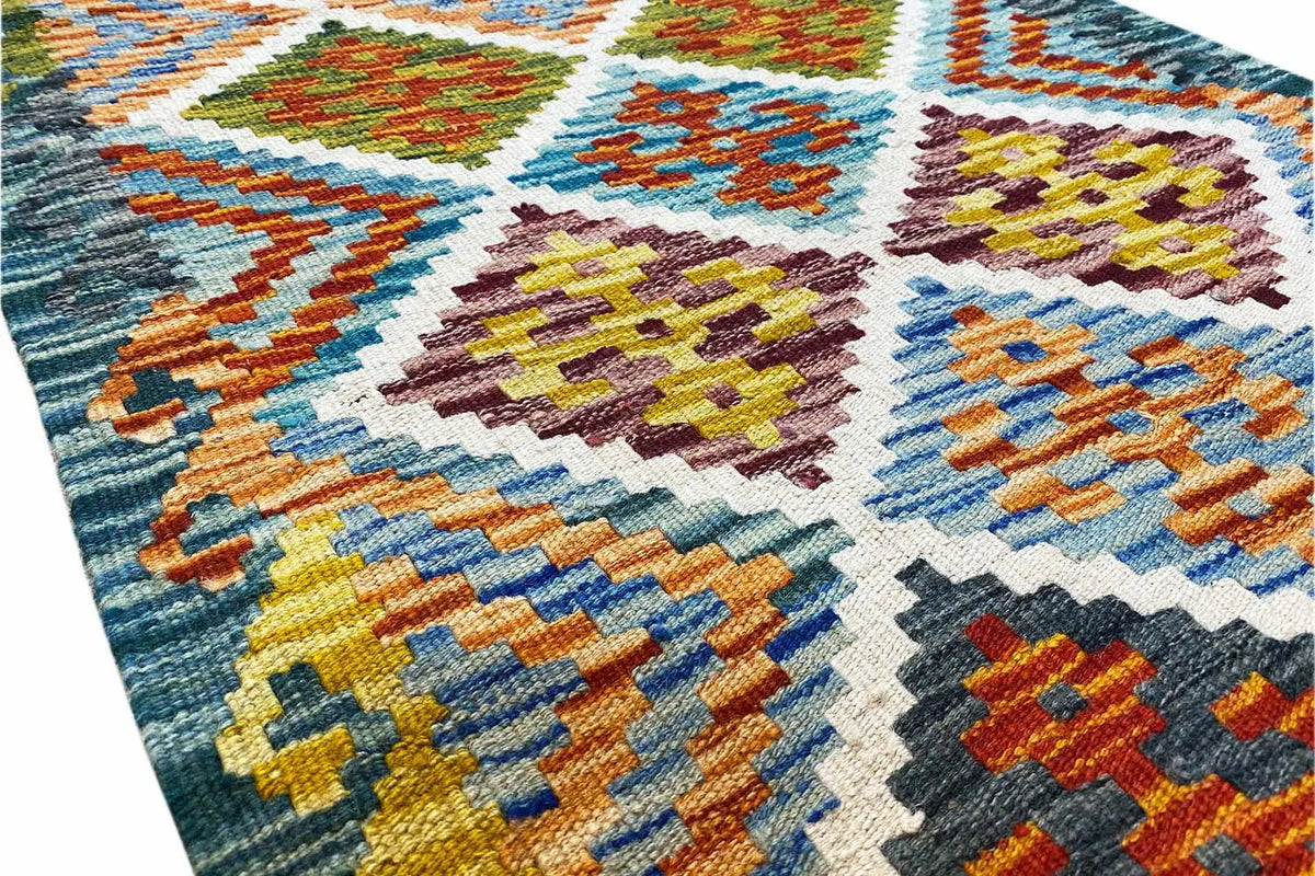 Afghan kilim runner: Detail with colorful cross and diamond motifs in the weave