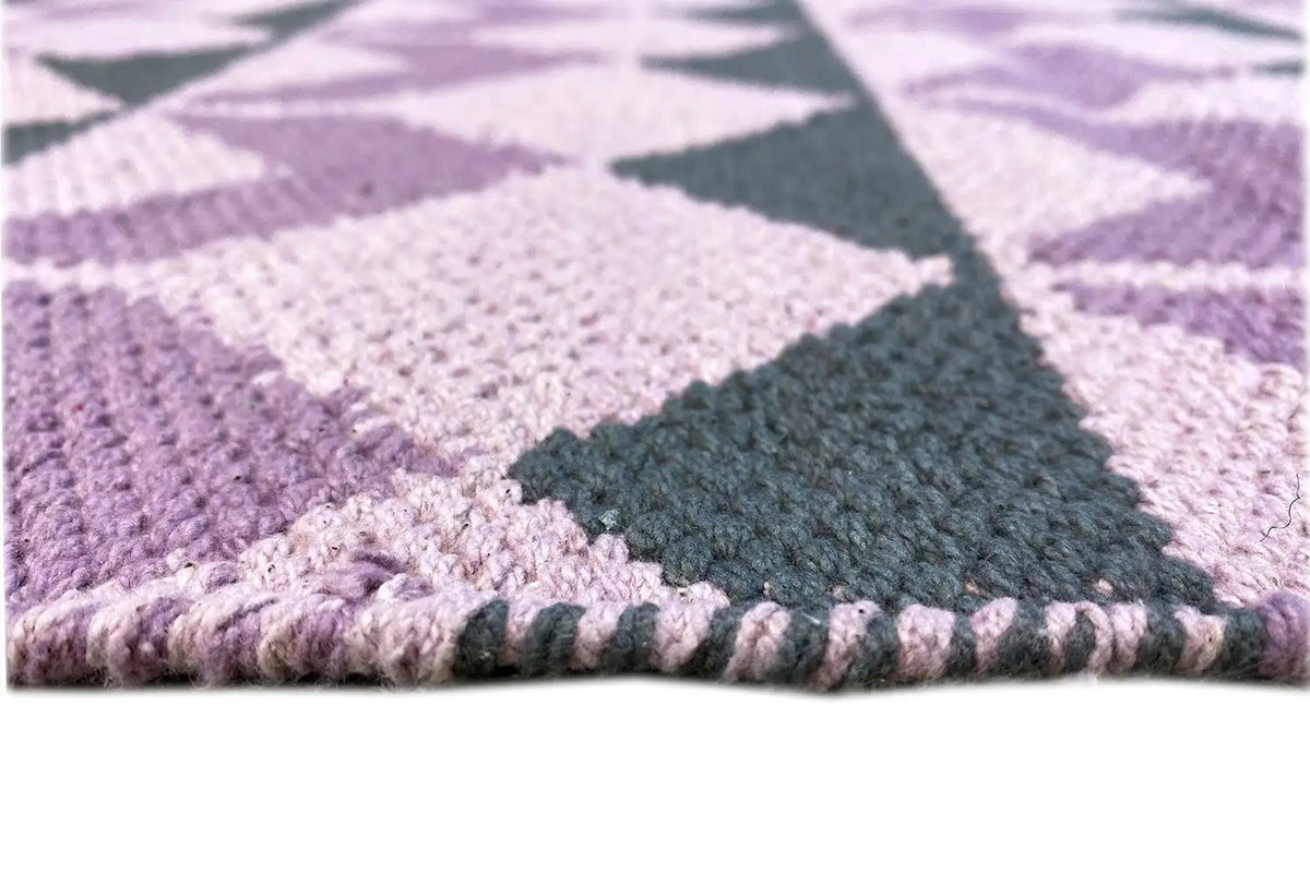 Hem border with a purple pattern and fringe trim, with dark green accents underneath