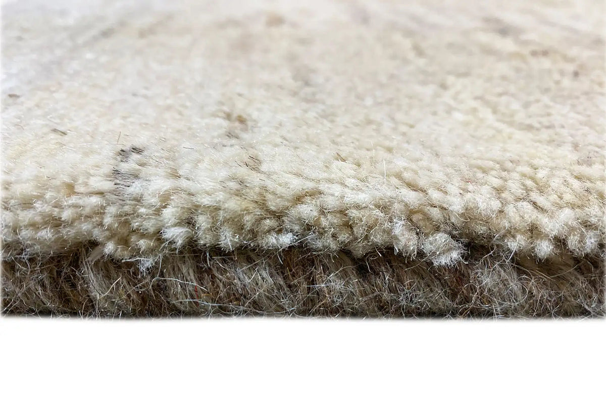 Gabbeh rug, detail of the pile edge with a short fringe border in cream