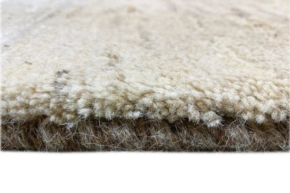 Gabbeh rug, detail of the pile edge with a short fringe border in cream