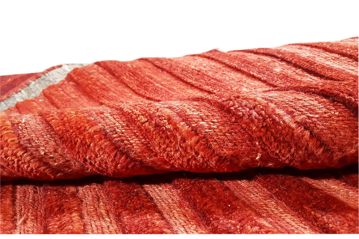 Close-up of a red carpet with a crimped, textured pile surface