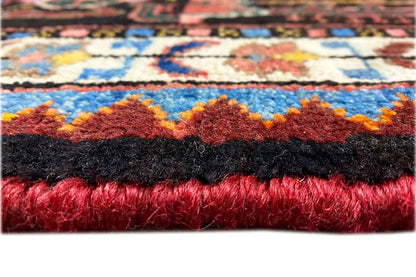 Carpet edge with fringe, red and black fiber bundles, visible weave structure