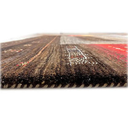 Gabbeh rug edge view with dark pile and colorful blocks of color along the edge