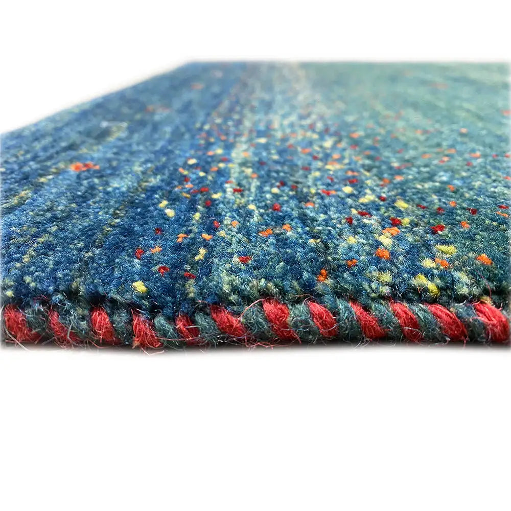Gabbeh rug 91x63 cm close-up: blue-green pile with colorful dots, short fringes